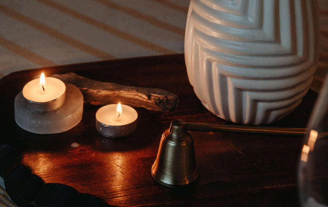 A quiet still life of candles on a wooden table