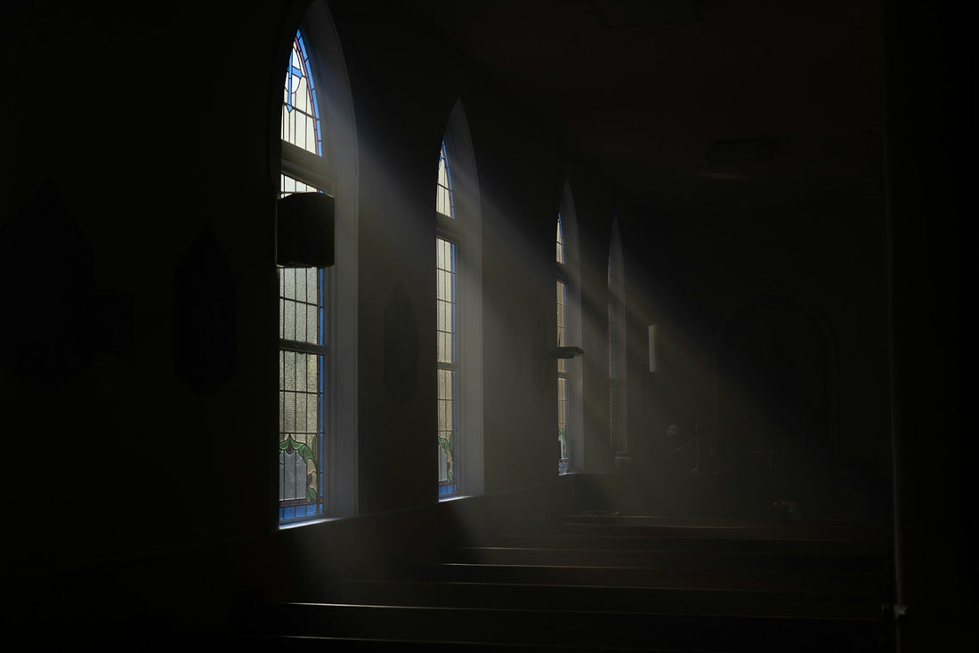 Sunlight streaming through windows into a quiet dark room