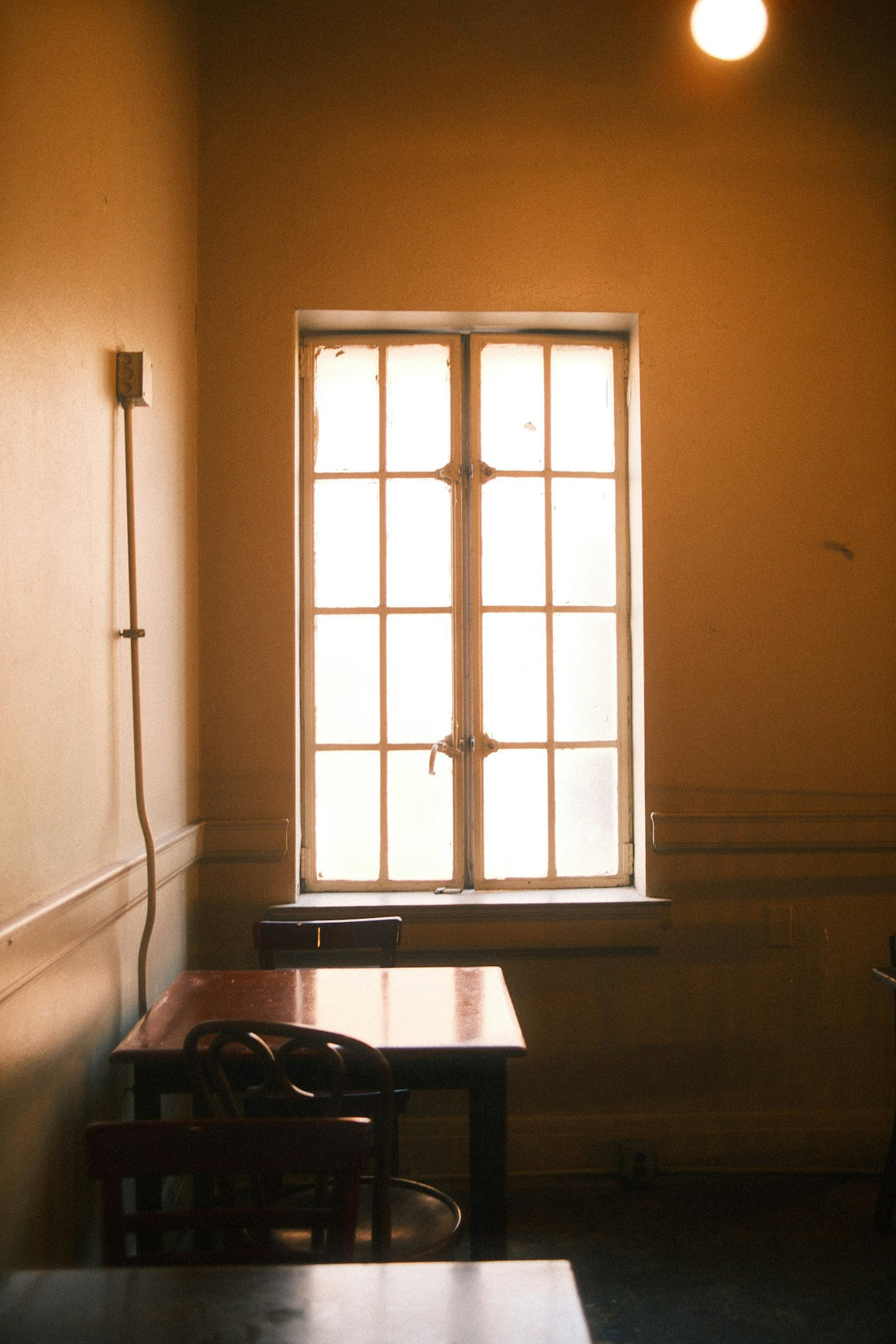 Sunlight streaming through a window into an empty room