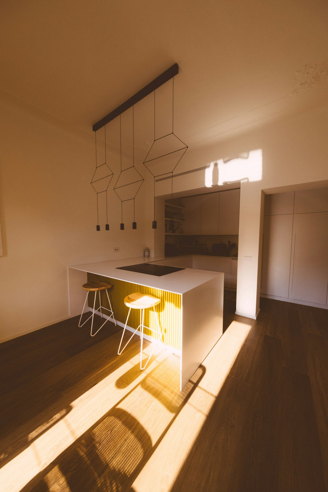A modern kitchen island illuminated by sunlight