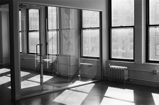Sunlight and window shadows across an empty office room