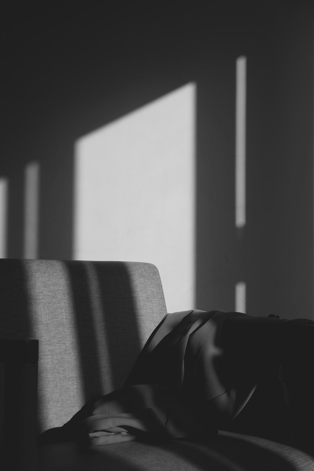 Sunlight through blinds onto a quiet chair