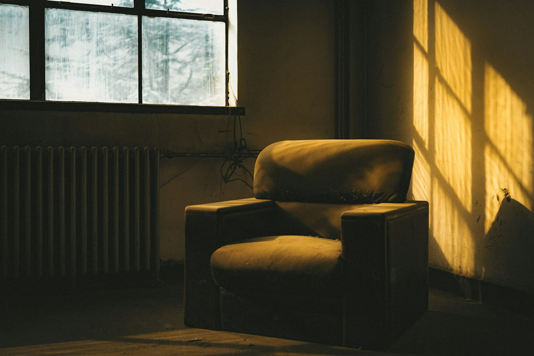 A quiet chair in a sunlit room beside a window