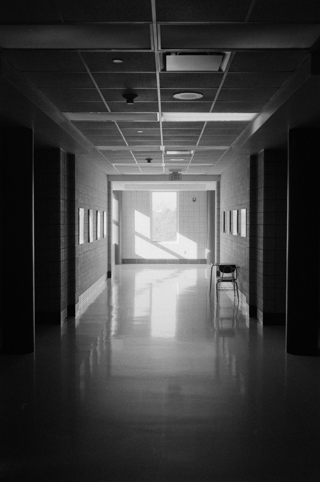 A long, empty hallway with sunlight streaming in