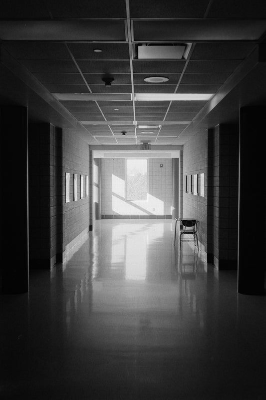 A long, empty hallway with sunlight streaming in