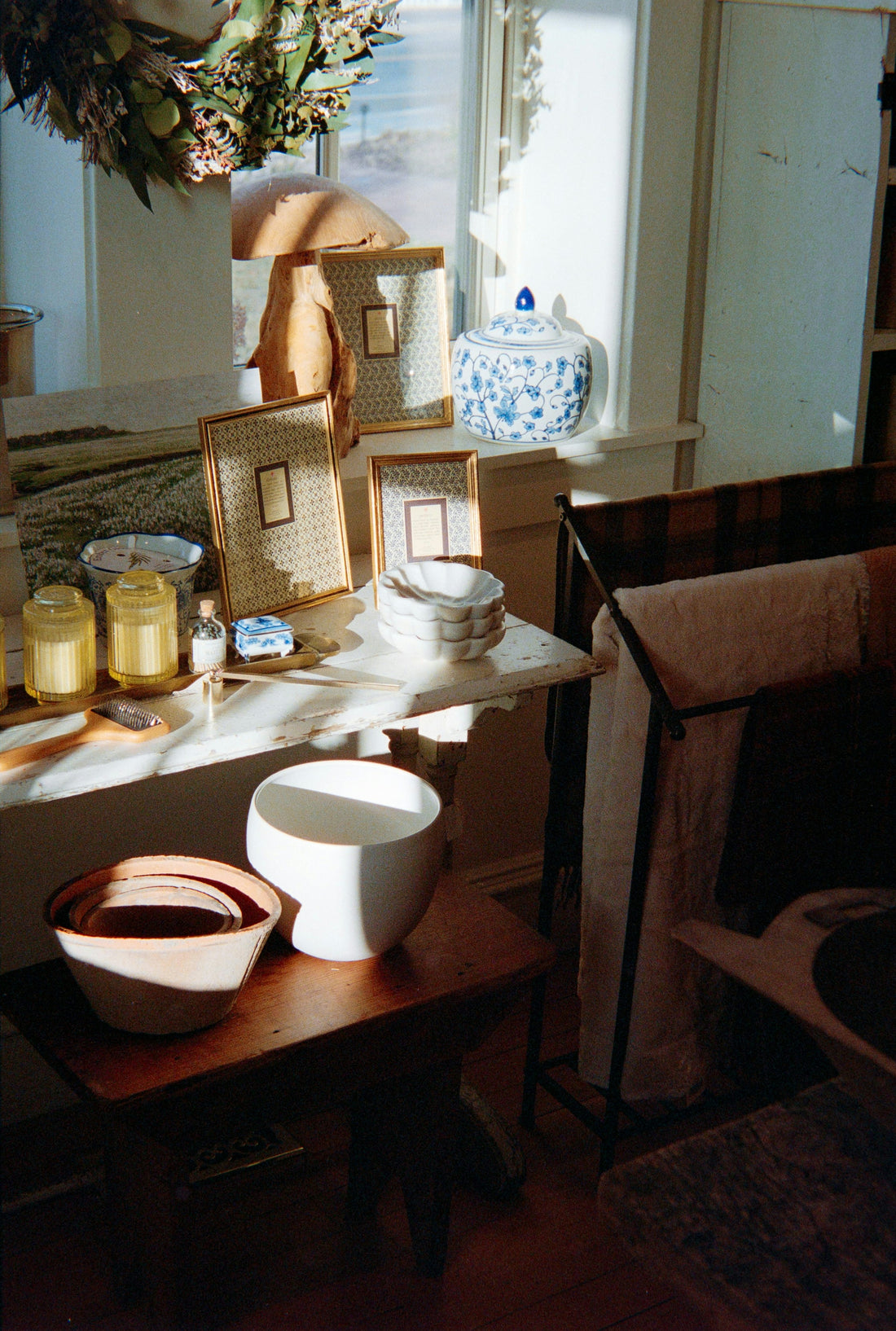 Sunlight across a calm shelf with bowls and jars